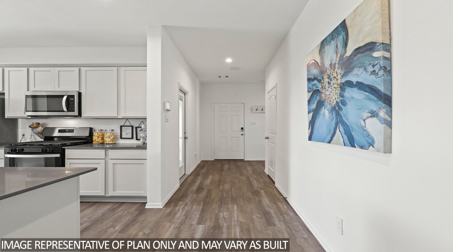 Entryway and foyer with vinyl flooring.