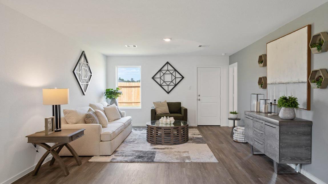 Spacious living area with vinyl flooring