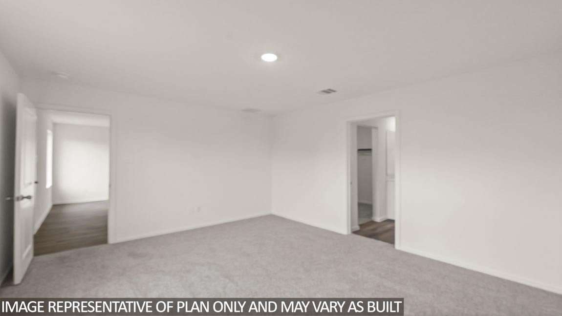 Primary bedroom with carpet flooring