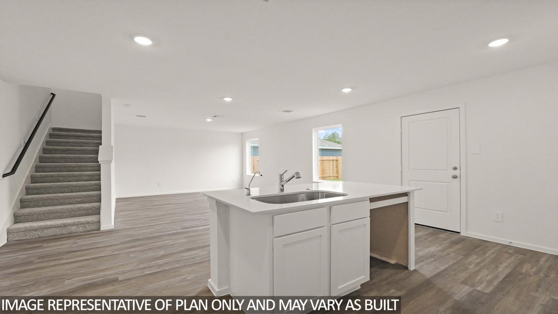 Kitchen with an island and a tall pantry.