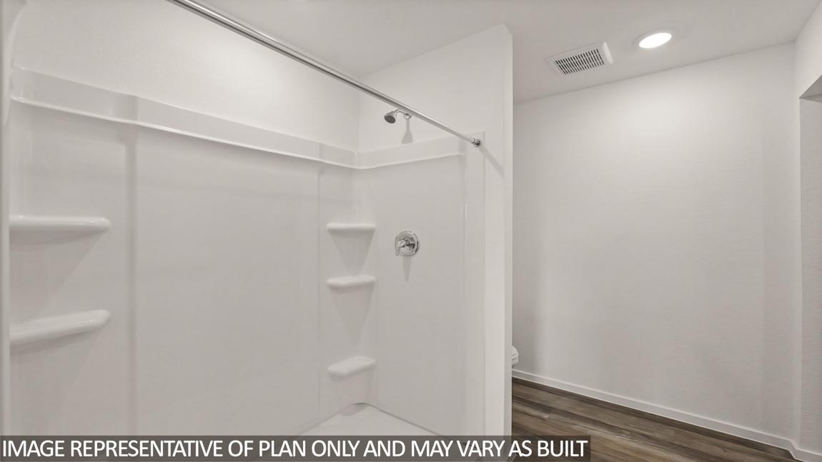 Primary bathroom with a tile standing shower, a double sink, a linen nook, a separate toilet room, and a walk-in closet.