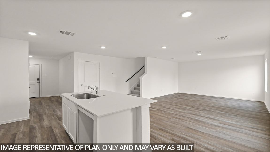 Kitchen with an island and a tall pantry.