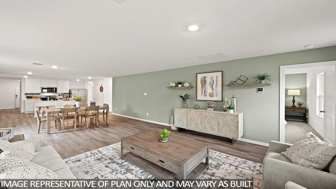 Spacious living area with vinyl flooring