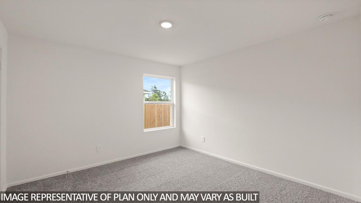 Secondary bedroom with carpet flooring