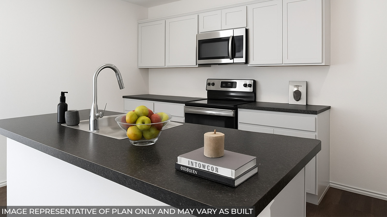 Staged kitchen with an island and stainless-steel appliances.