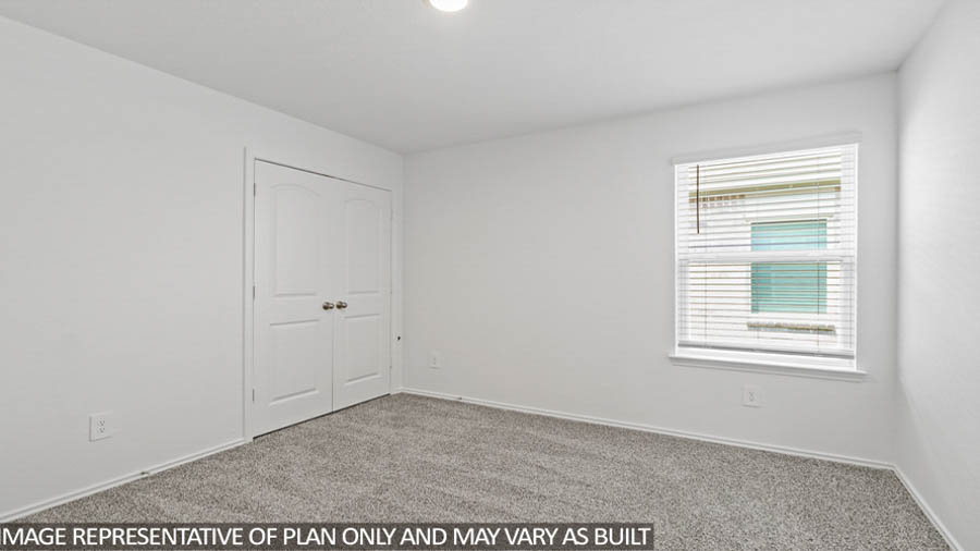Secondary bedroom with carpet flooring