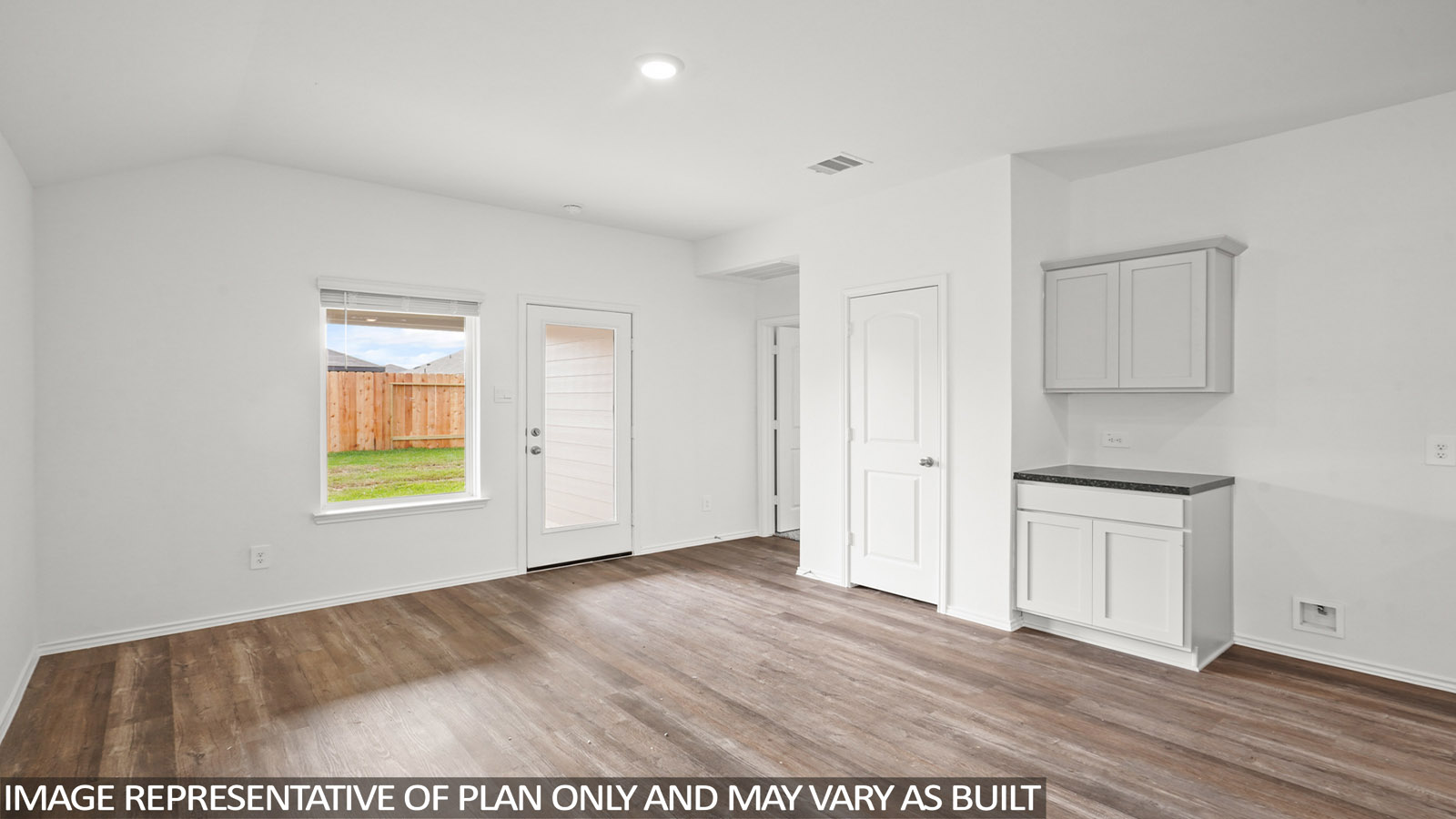 Open concept living and dining area with vinyl flooring and bright windows.