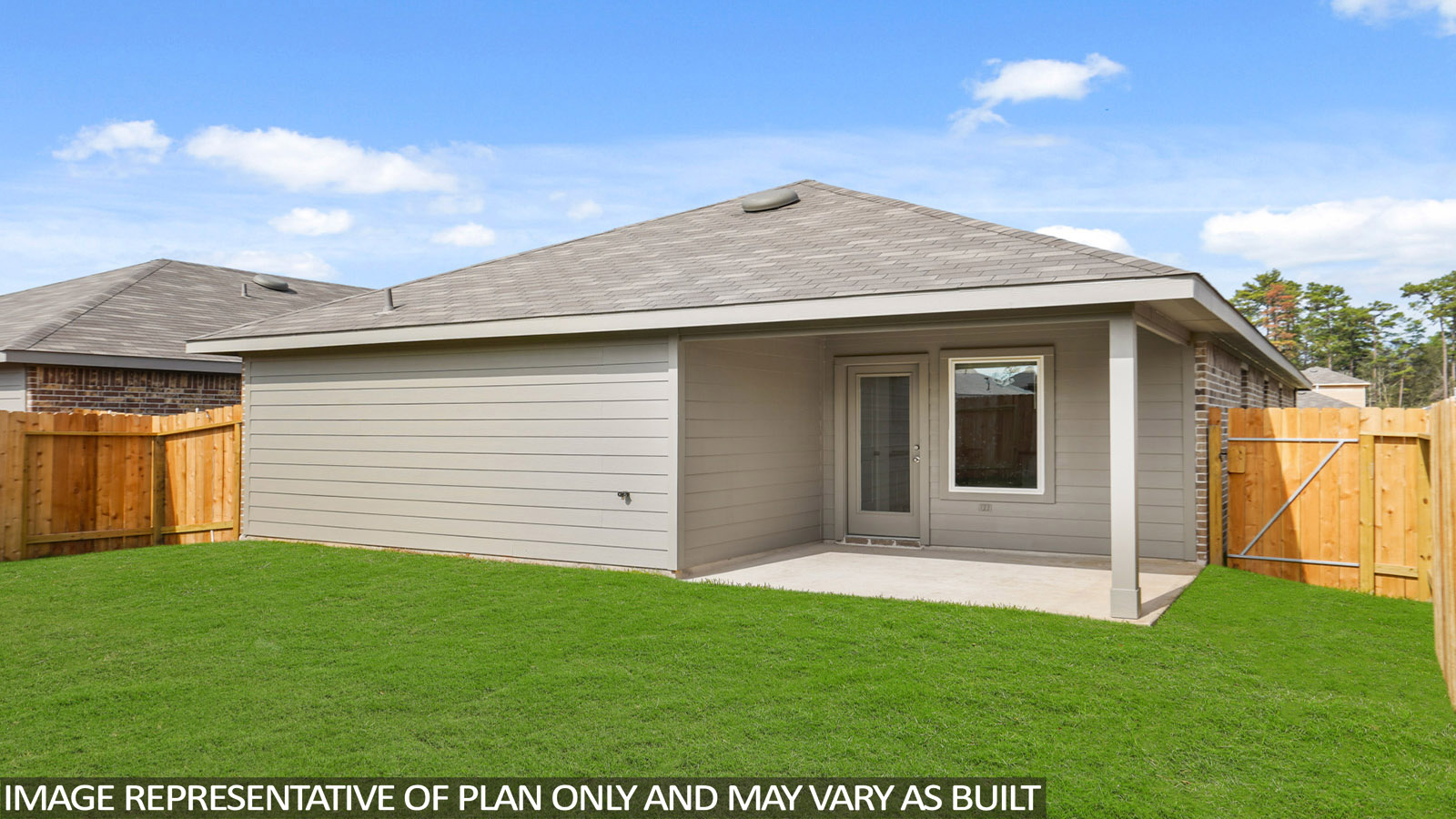 Spacious backyard with a back patio and overhead light.