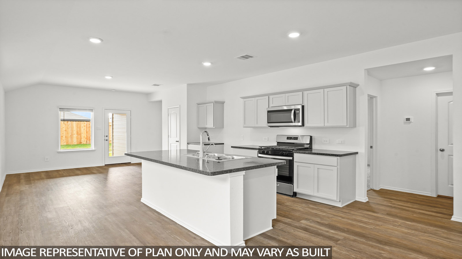 Kitchen with an island and stainless-steel appliances.