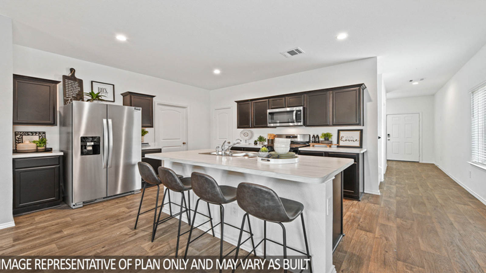 Kitchen with an island and stainless-steel appliances.