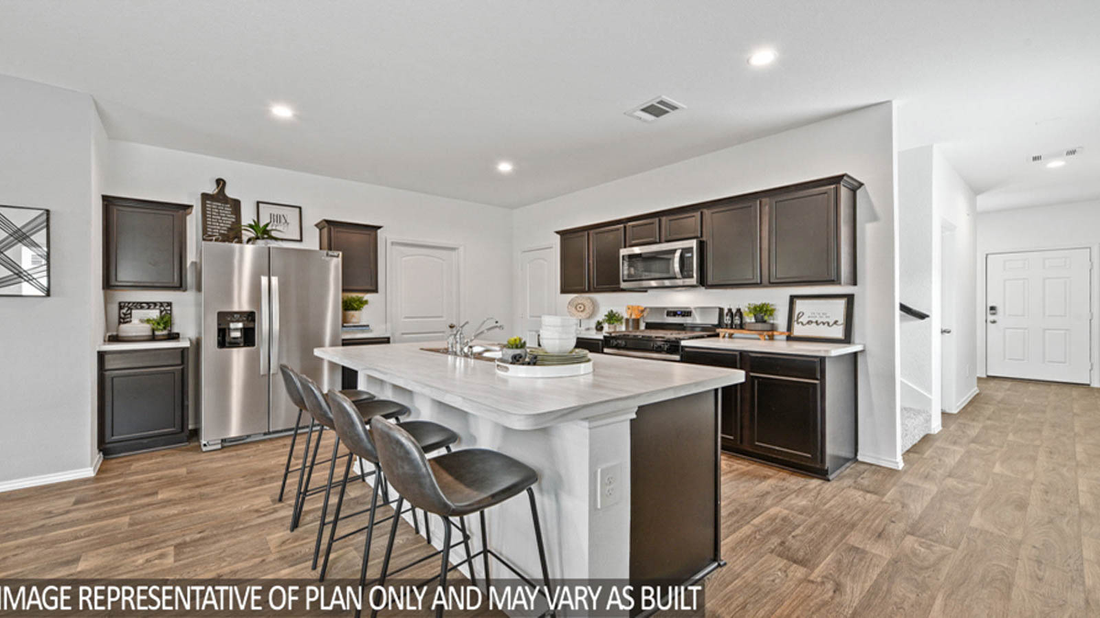 Kitchen with an island and stainless-steel appliances.