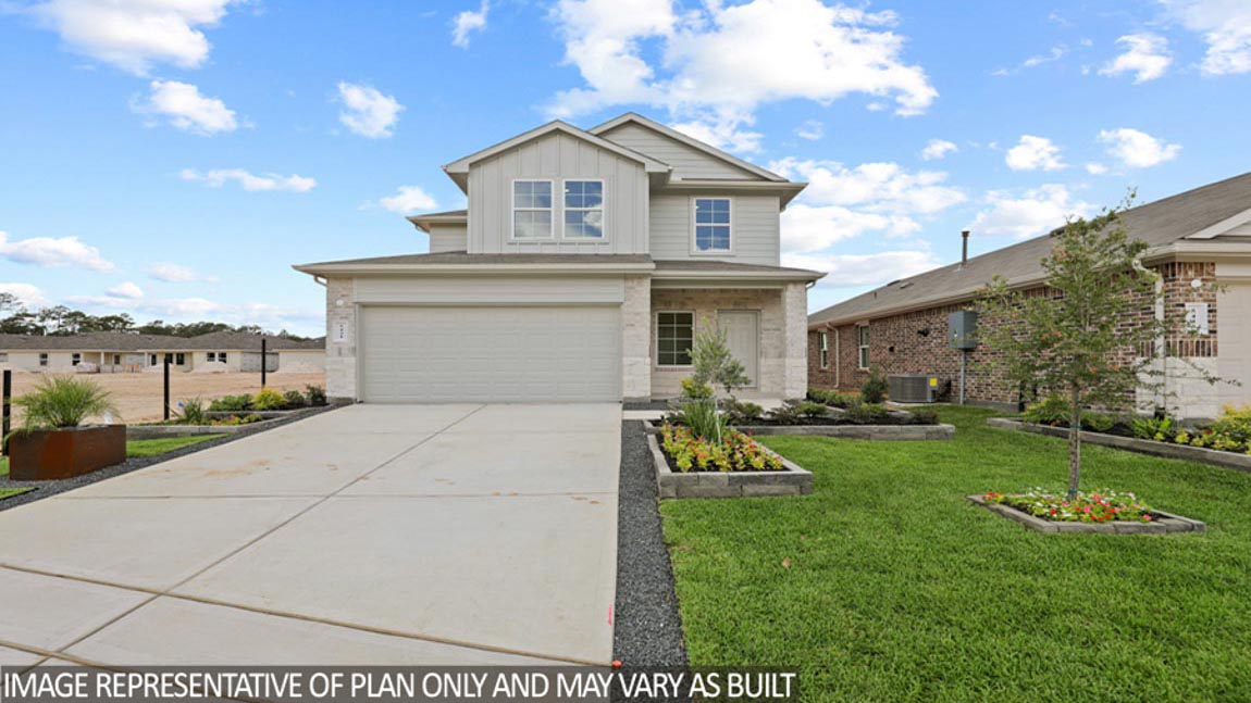 Two-story home with tan trim and a two-car garage.