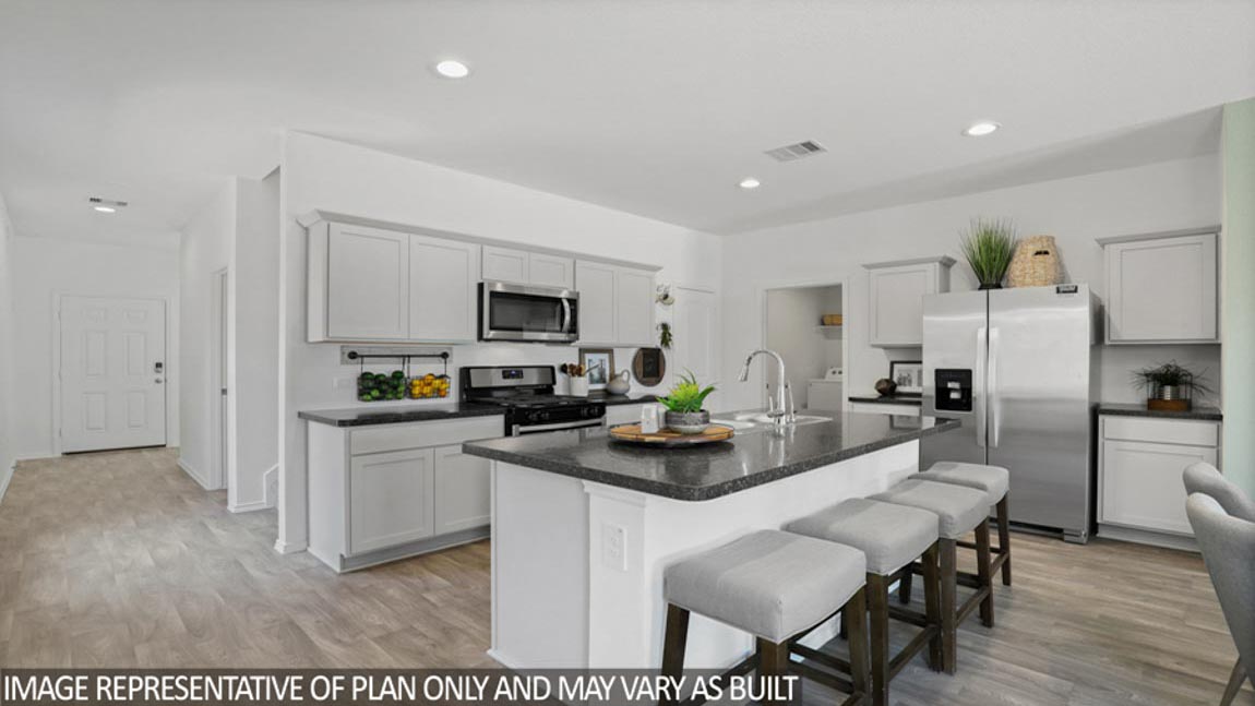 Kitchen with an island and stainless-steel appliances.