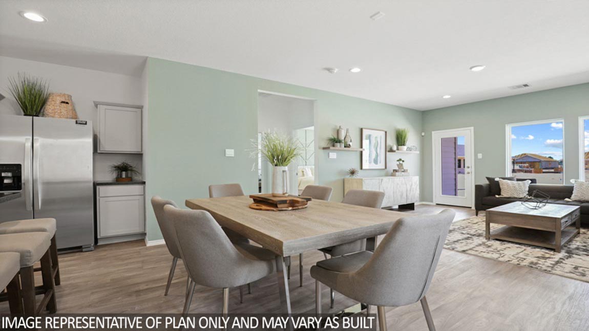 Open concept living and dining area with vinyl flooring and bright windows.