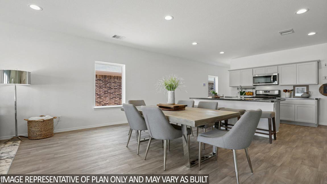 Open concept living and dining area with vinyl flooring and bright windows.