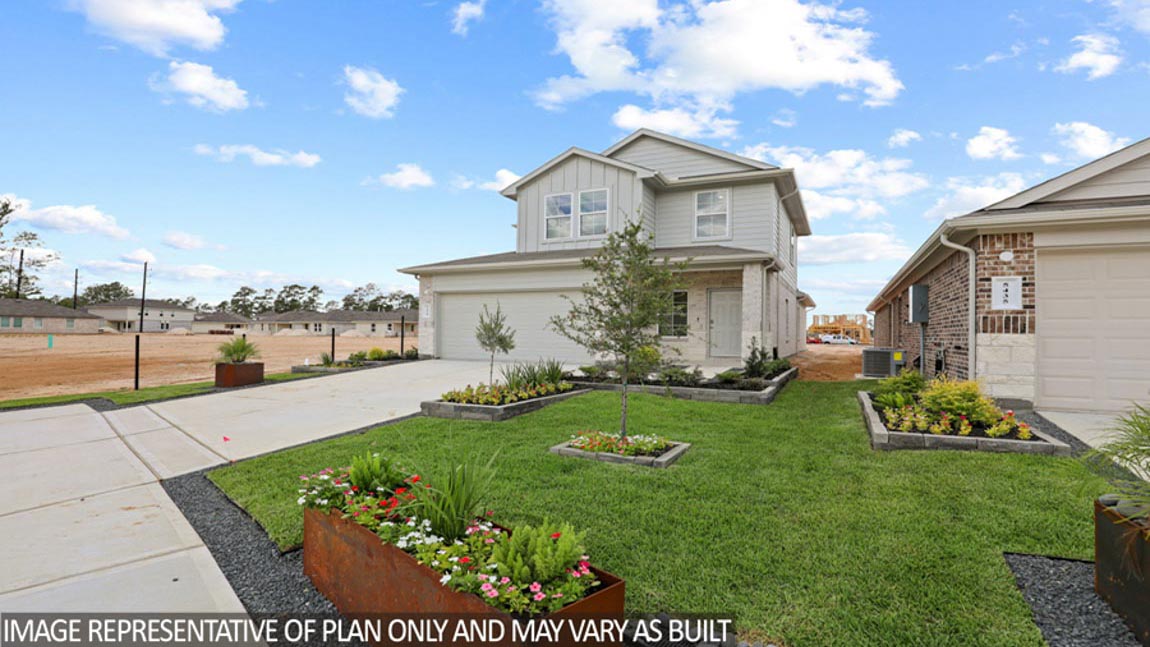 Two-story home with tan trim and a two-car garage.