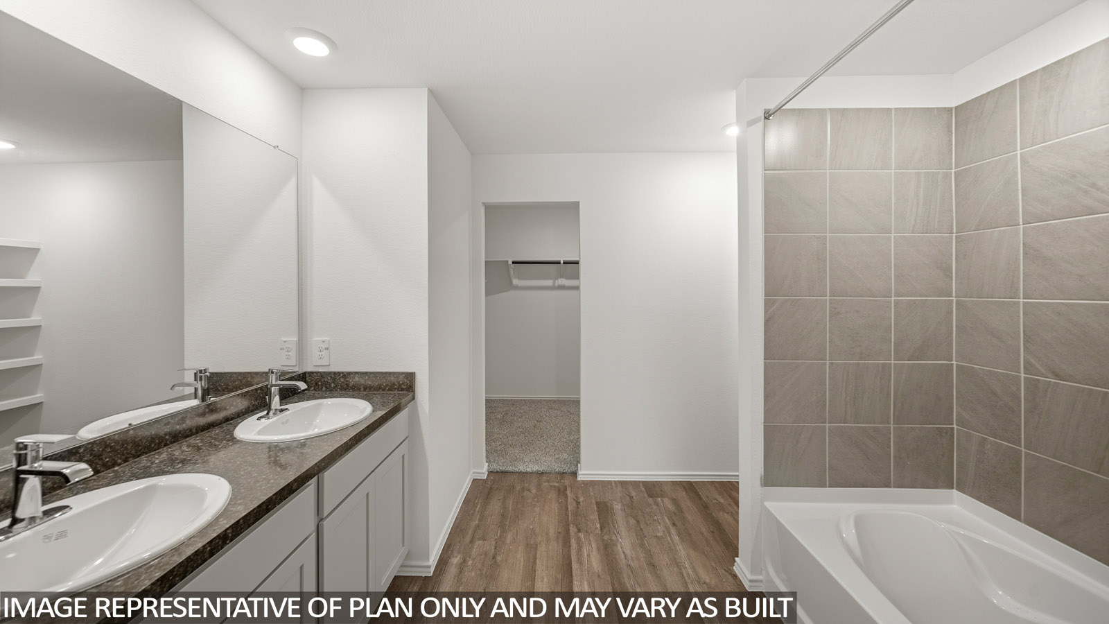 Primary bathroom with vinyl flooring, a double sink, a tile tub/shower combo, and a separate toilet room.