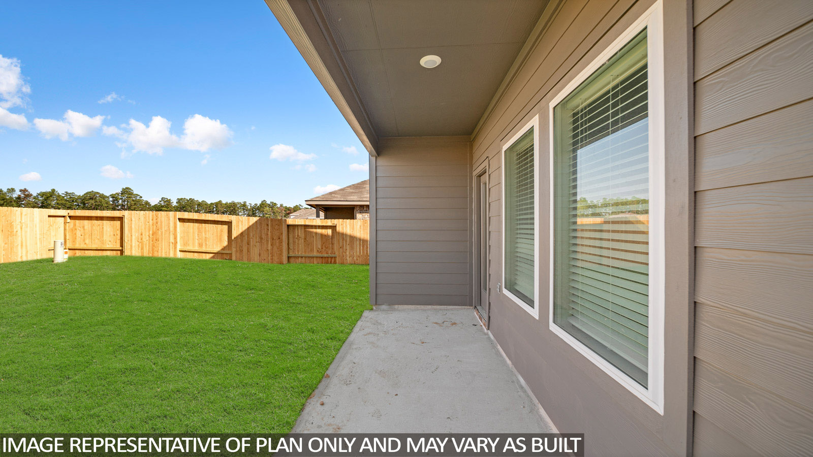 Spacious backyard with back patio and overhead light.