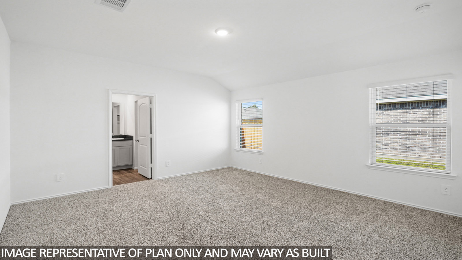 Primary bedroom with carpet flooring.