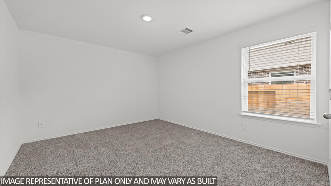 Secondary bedroom with carpet flooring
