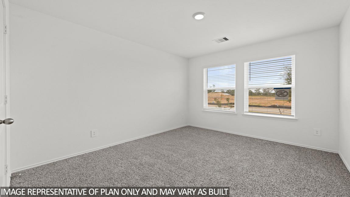 Secondary bedroom with carpet flooring