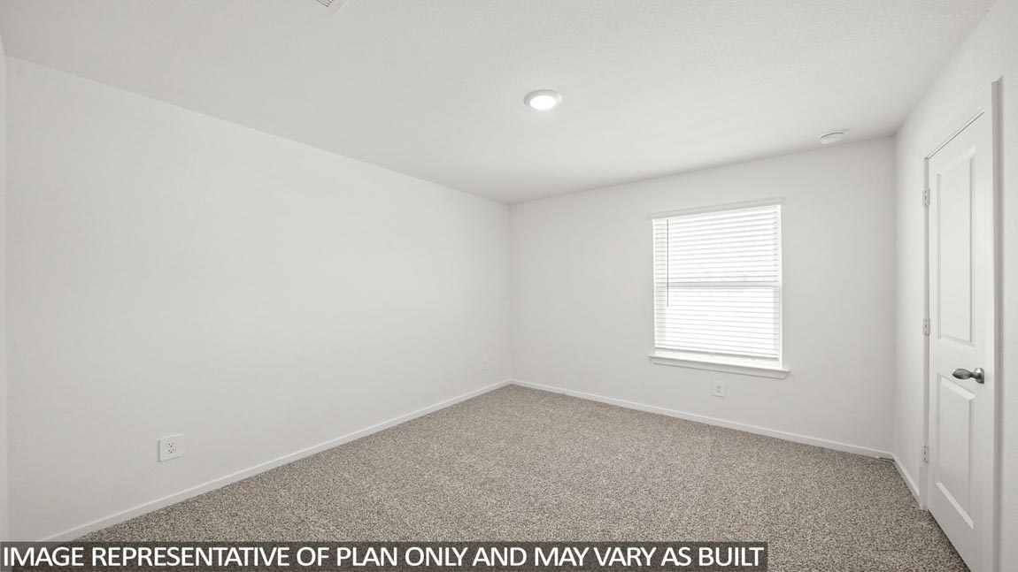 Secondary bedroom with carpet flooring