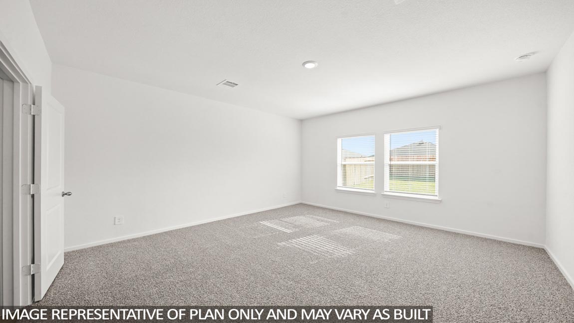 Primary bedroom with carpet flooring