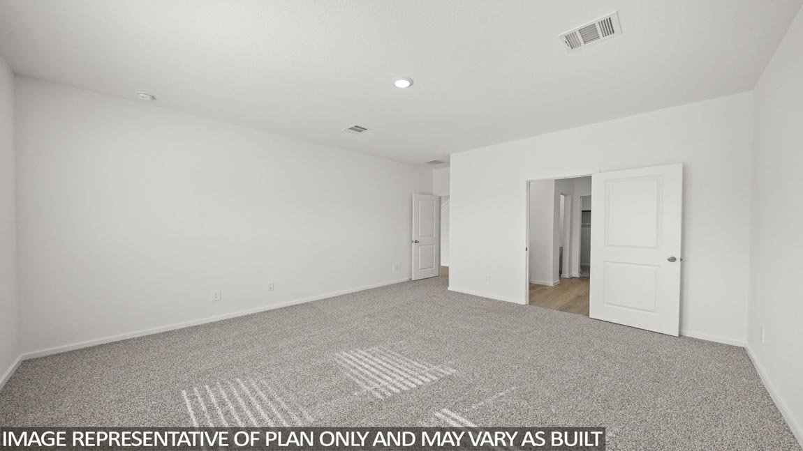 Primary bedroom with carpet flooring