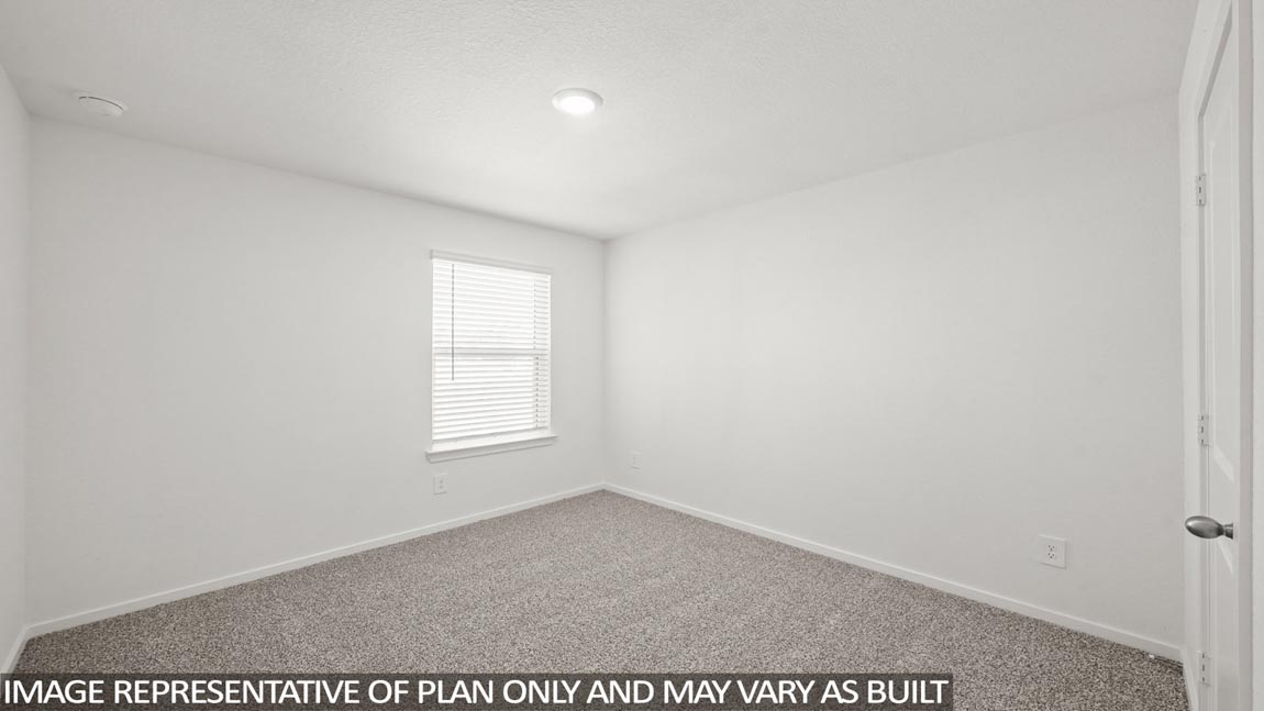 Secondary bedroom with carpet flooring