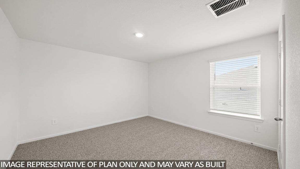 Secondary bedroom with carpet flooring