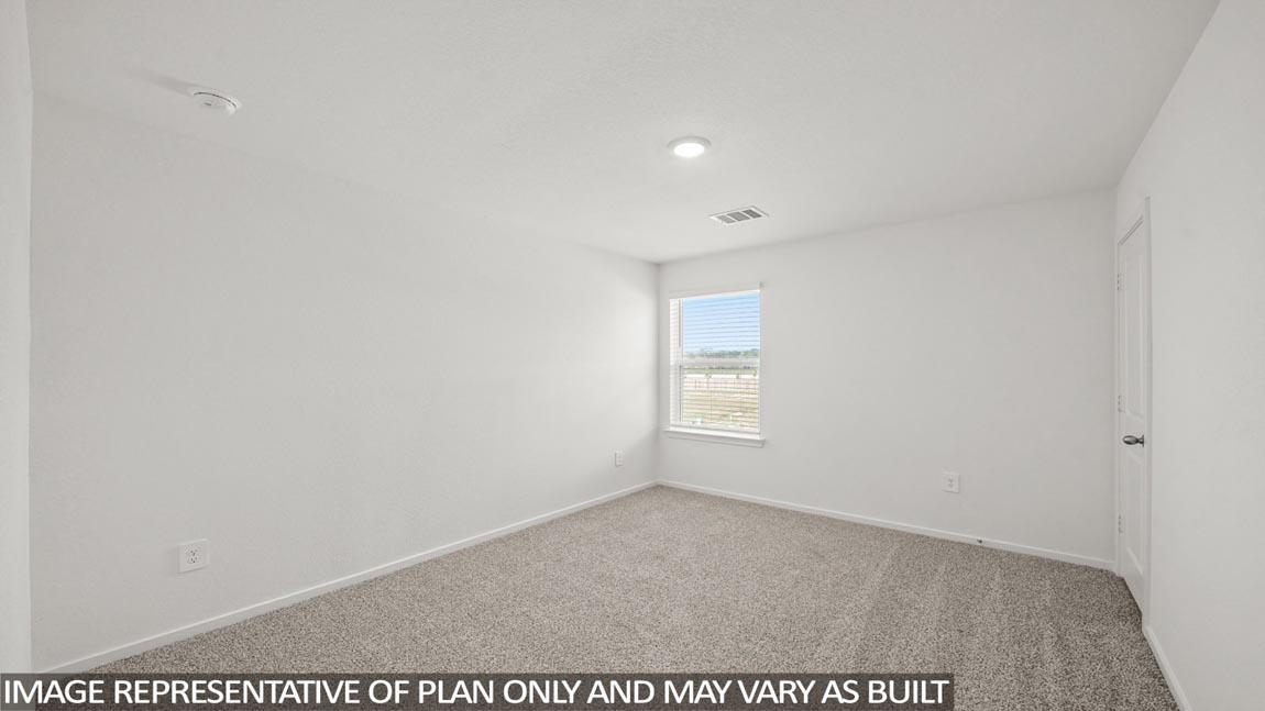 Secondary bedroom with carpet flooring