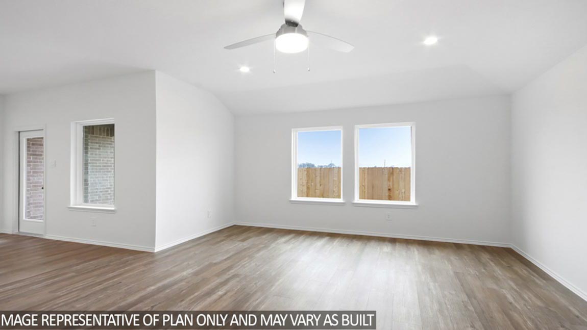 Spacious living area with vinyl flooring