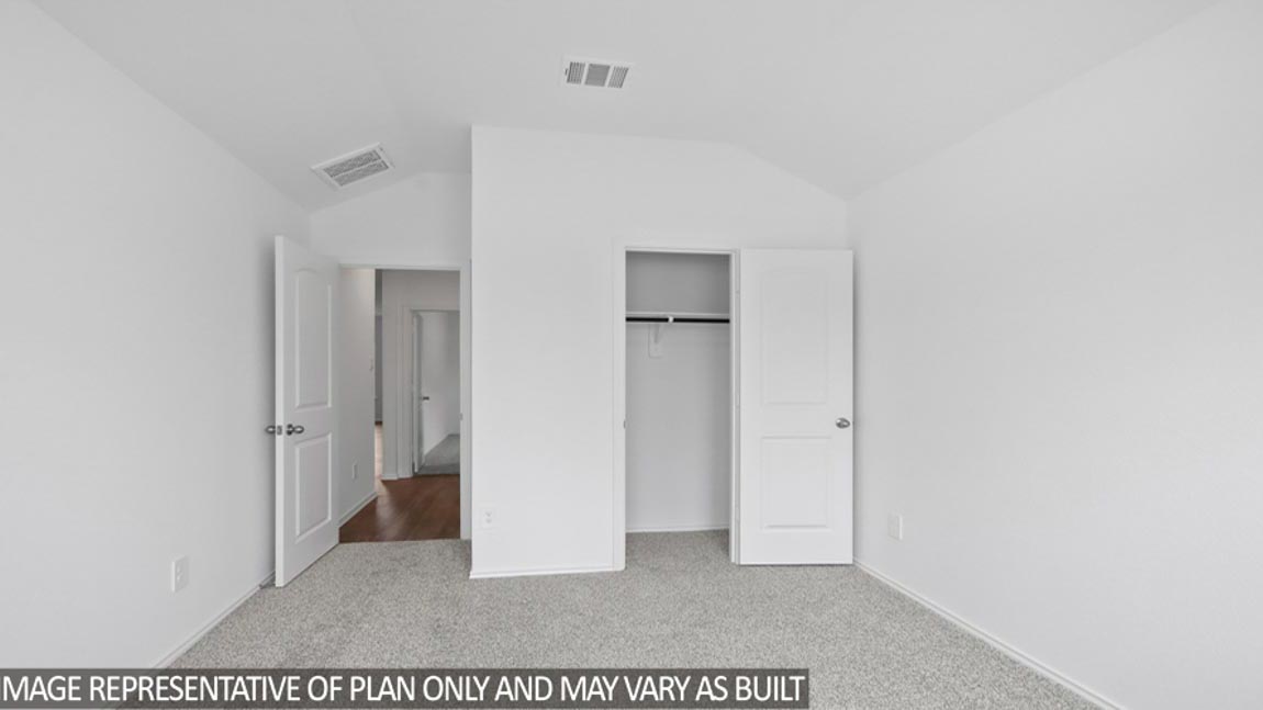 Secondary bedroom with carpet flooring