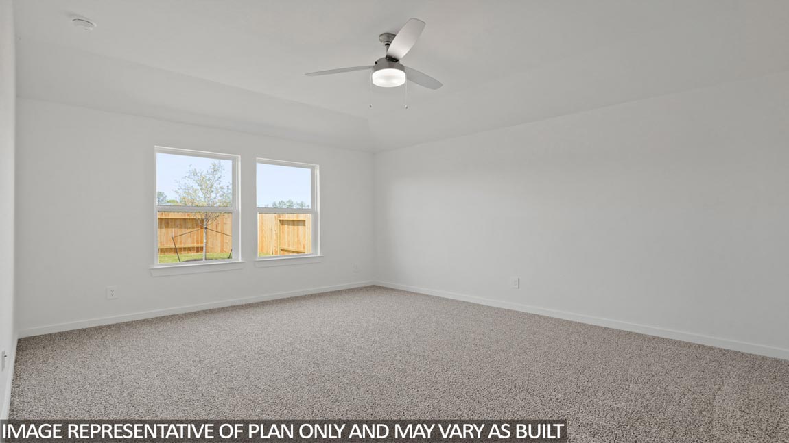Primary bedroom with bright windows