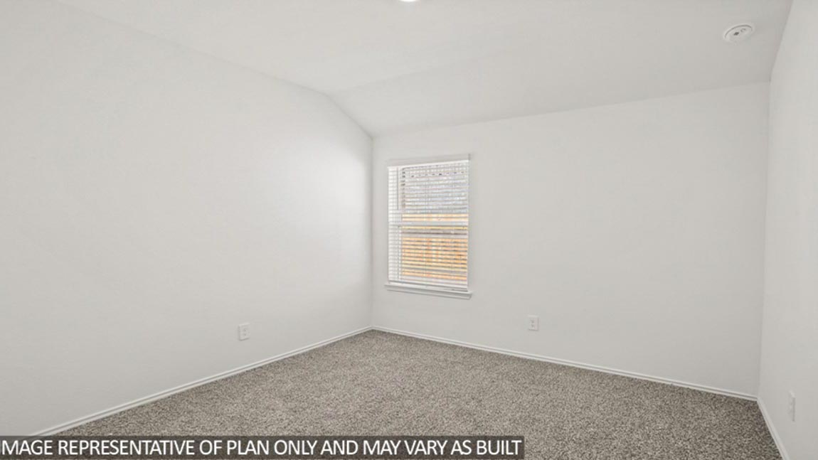 Secondary bedroom with carpet flooring