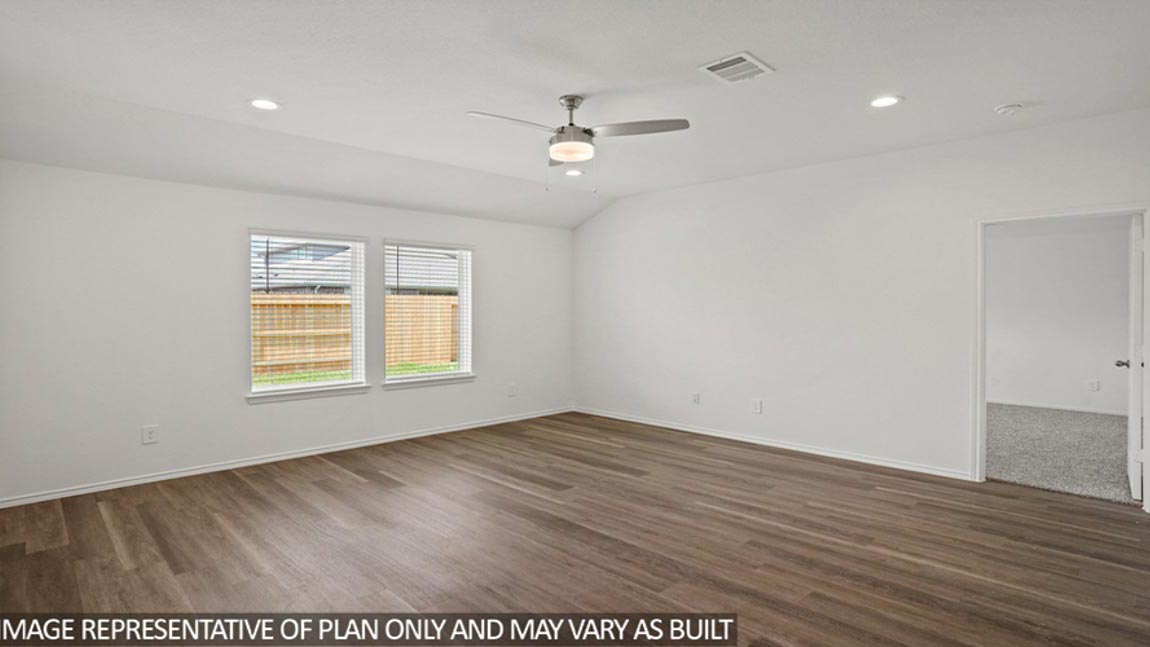 Spacious living area with vinyl flooring