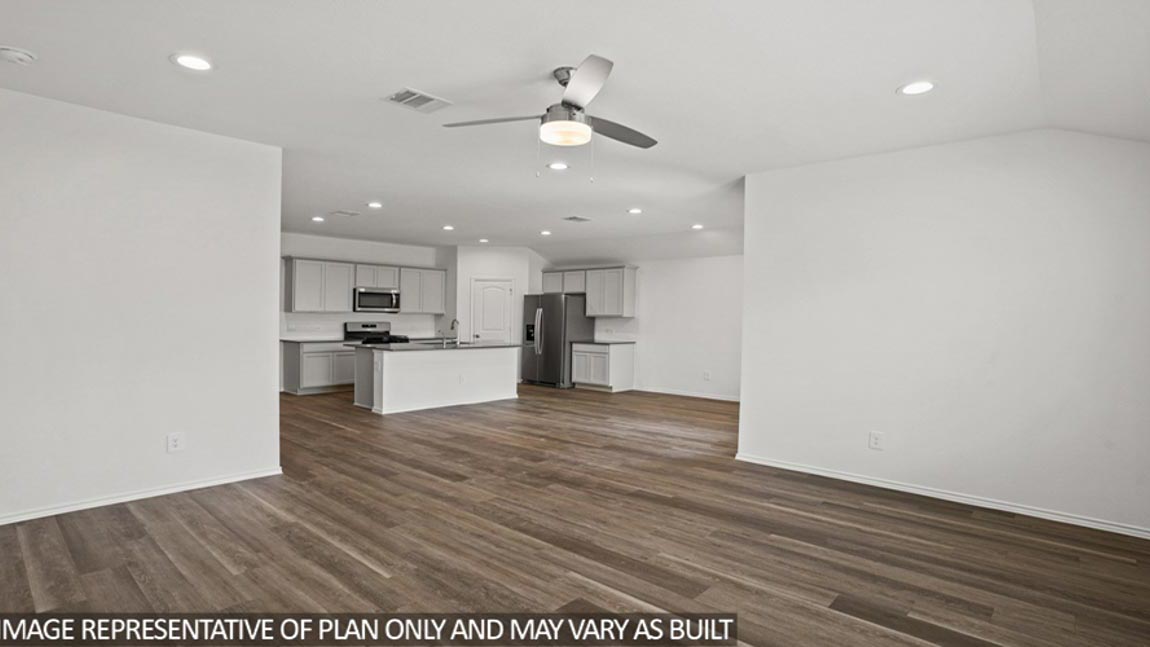 Spacious living area with vinyl flooring