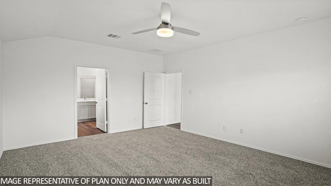 Primary bedroom with carpet flooring