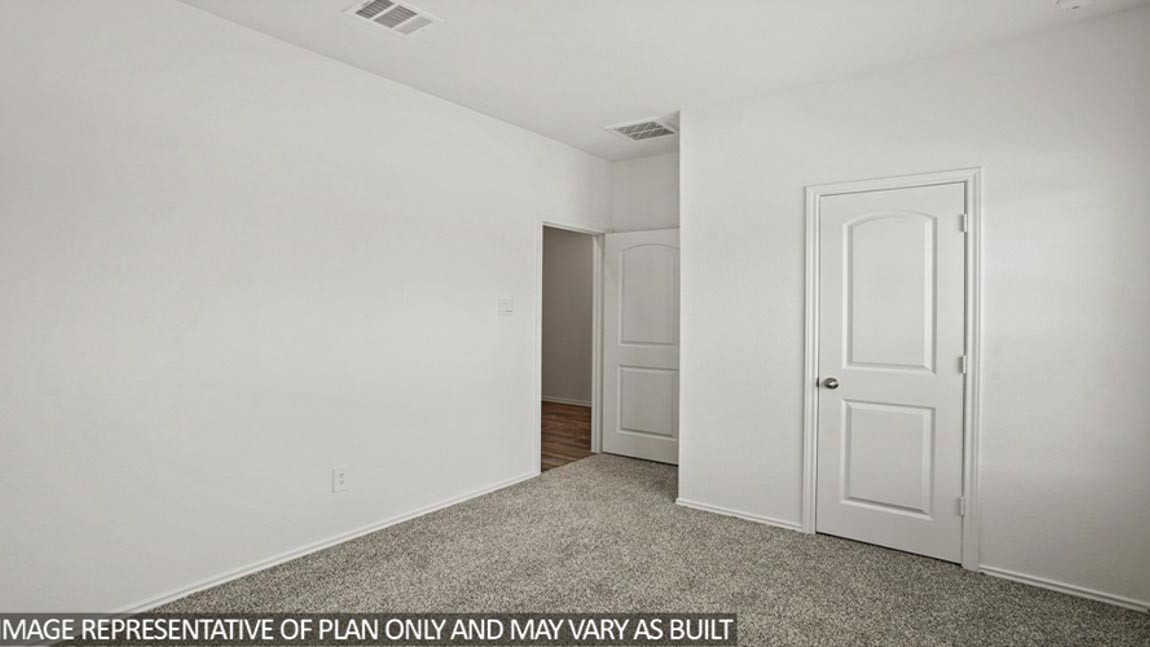 Secondary bedroom with carpet flooring
