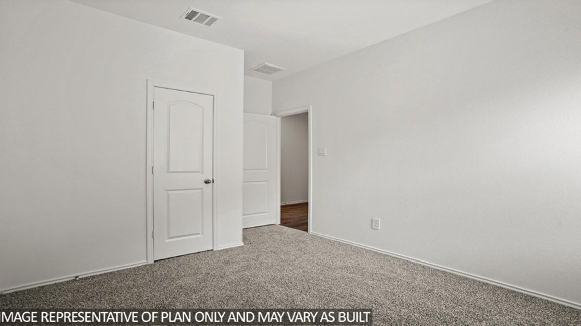 Secondary bedroom with carpet flooring
