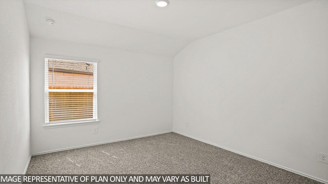 Secondary bedroom with carpet flooring