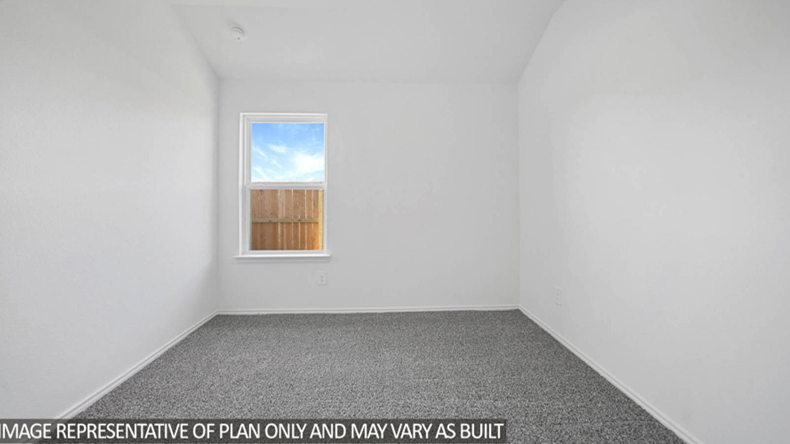 Secondary bedroom with carpet flooring