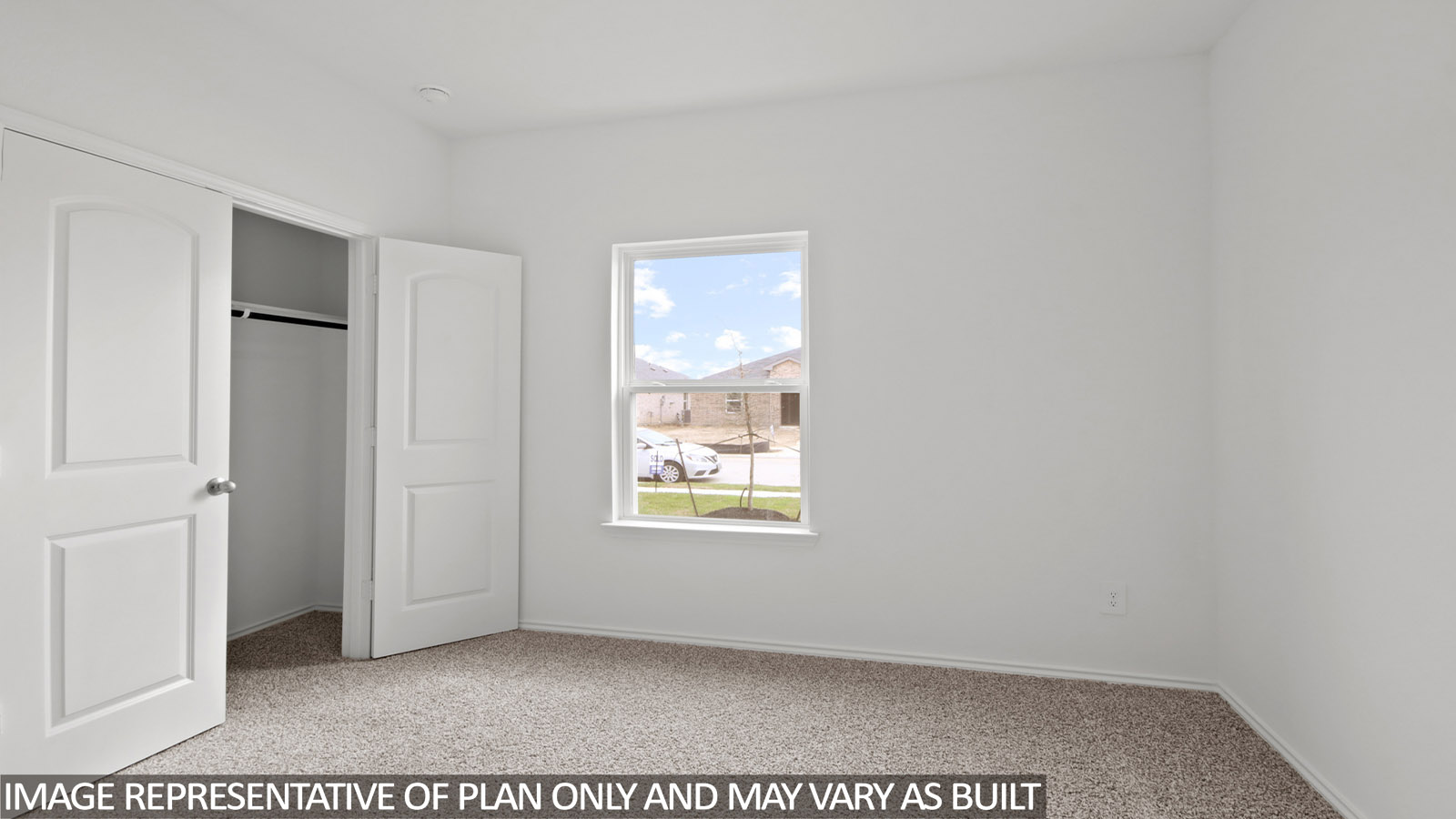 Secondary bedroom with carpet flooring