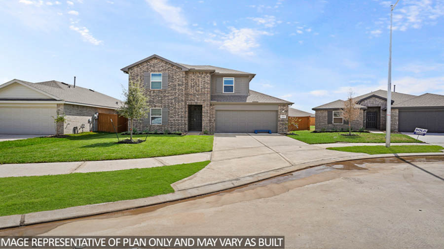 Two-story home with tan trimming and a two-car garage.