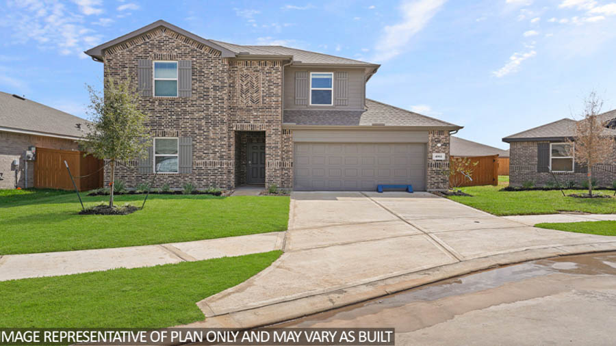 Two-story home with tan trimming and a two-car garage.