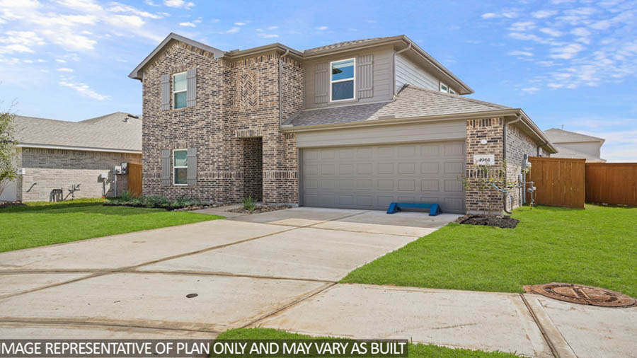 Two-story home with tan trimming and a two-car garage.