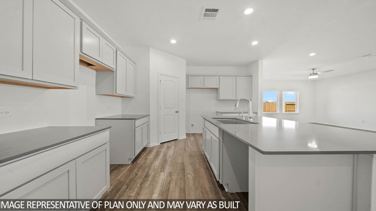 Kitchen with an island and vinyl floor