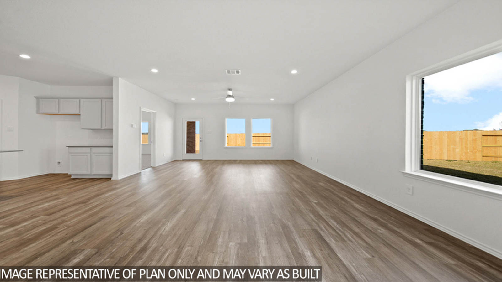 Spacious living area with vinyl flooring