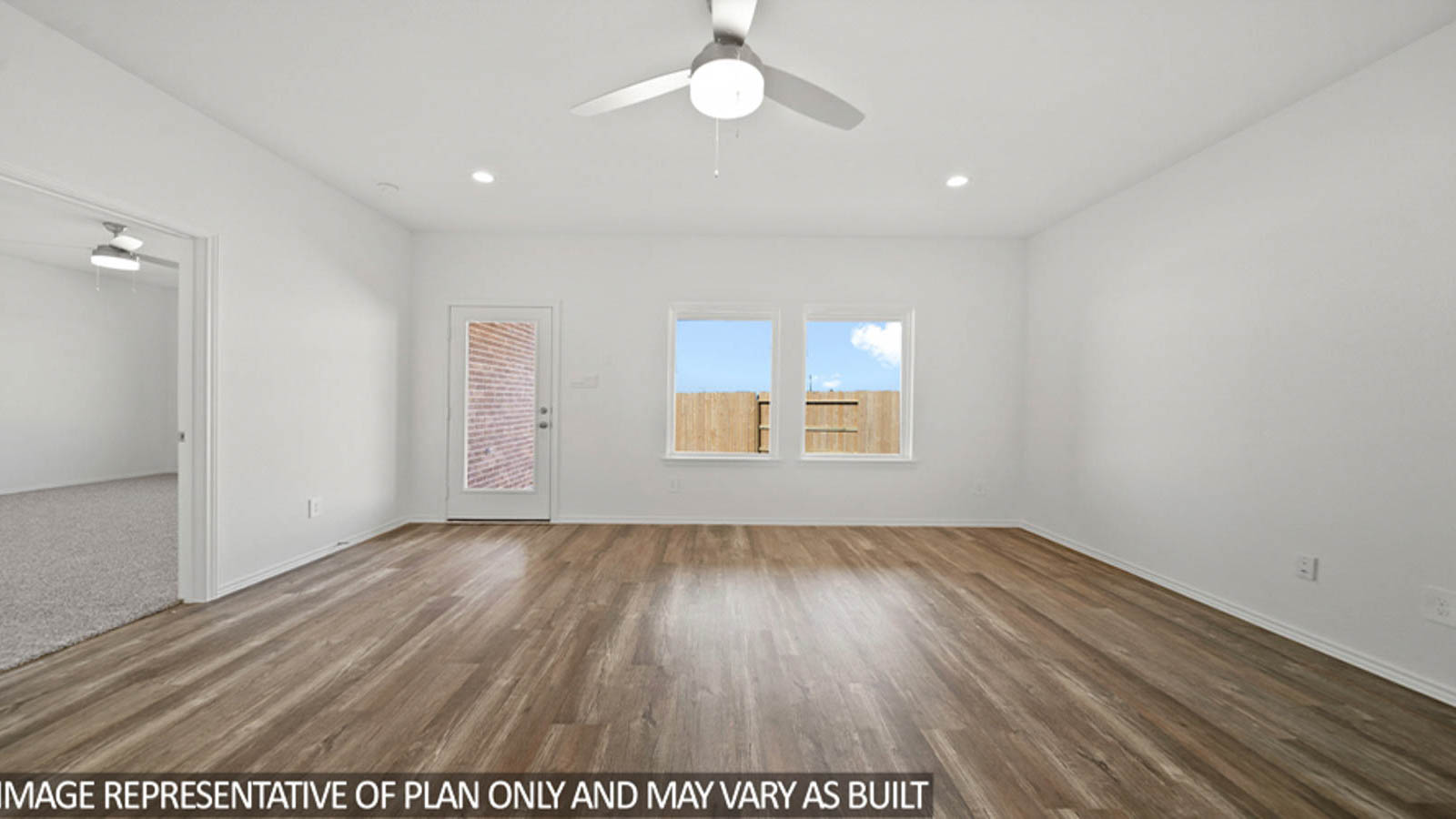 Spacious living area with vinyl flooring