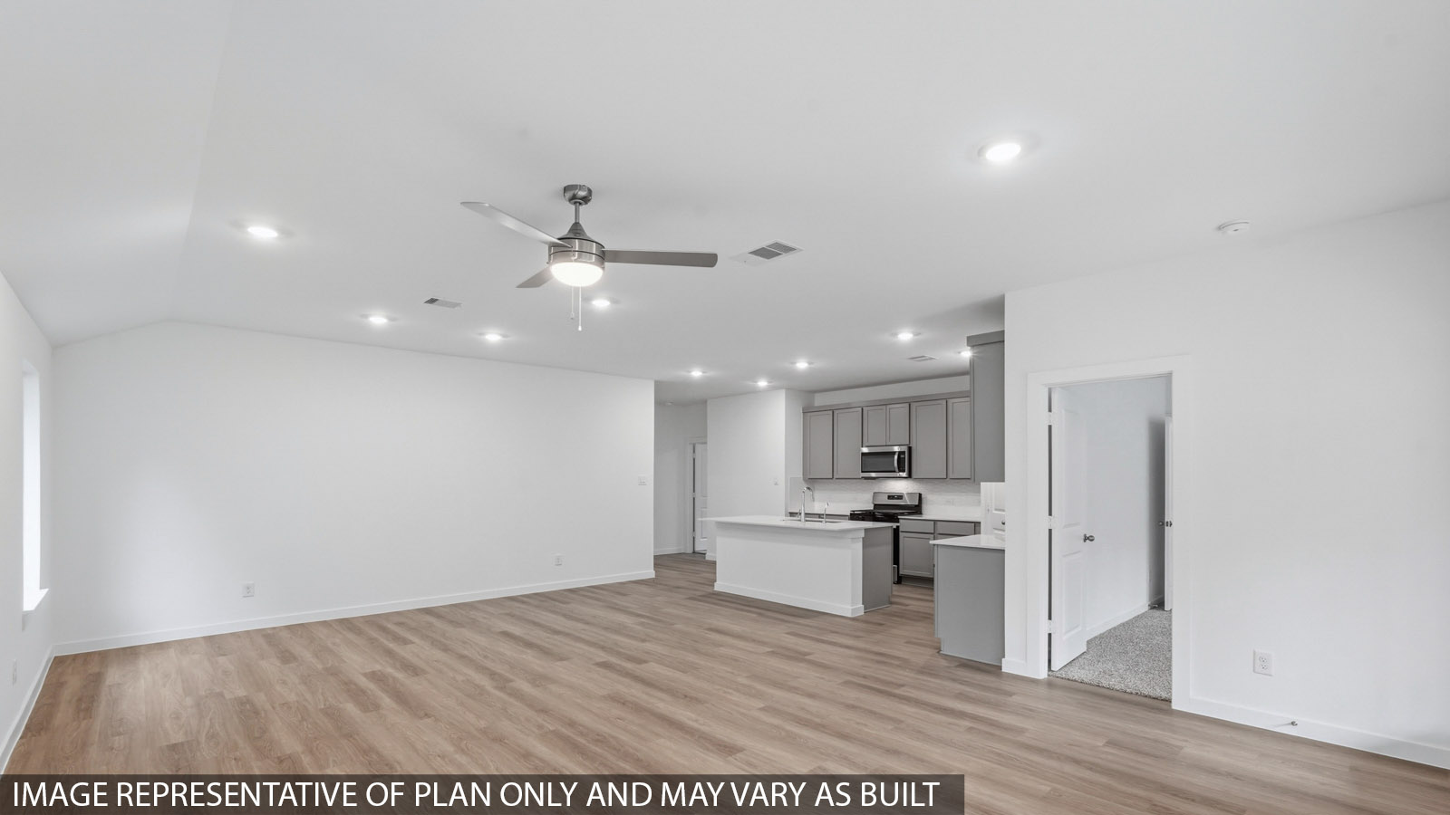 Spacious living area with vinyl flooring